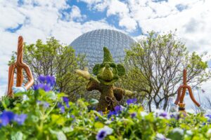 mickey mouse flower sculpture in front of Disneys Epcot ball