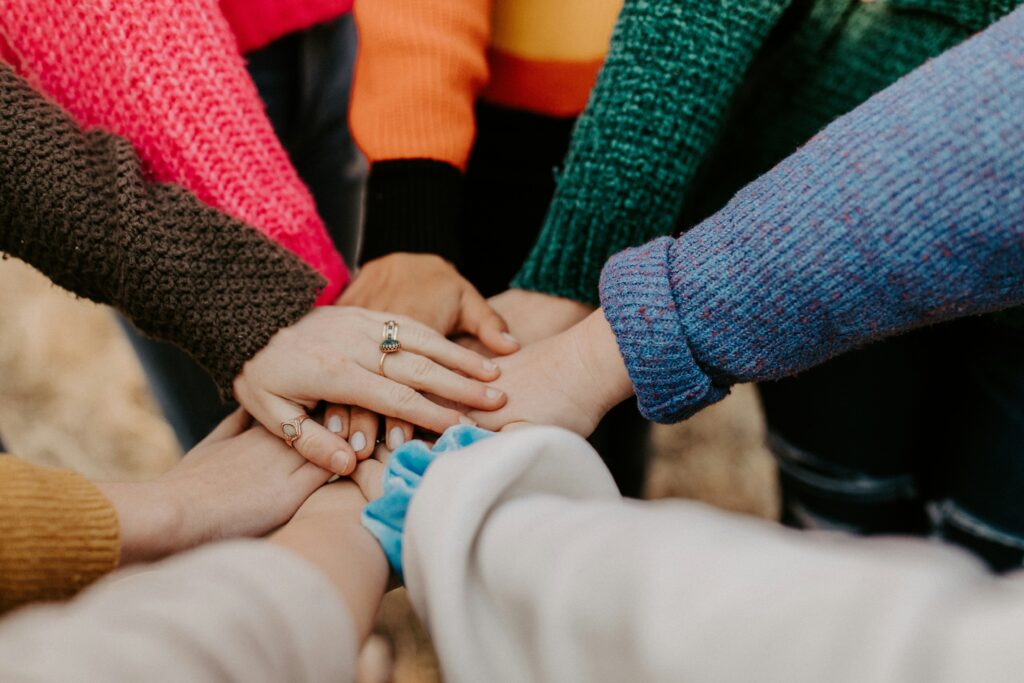 volunteers putting their hands in a circle