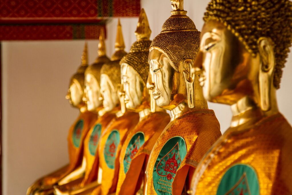 A close up of golden Buddha statues in Thailand