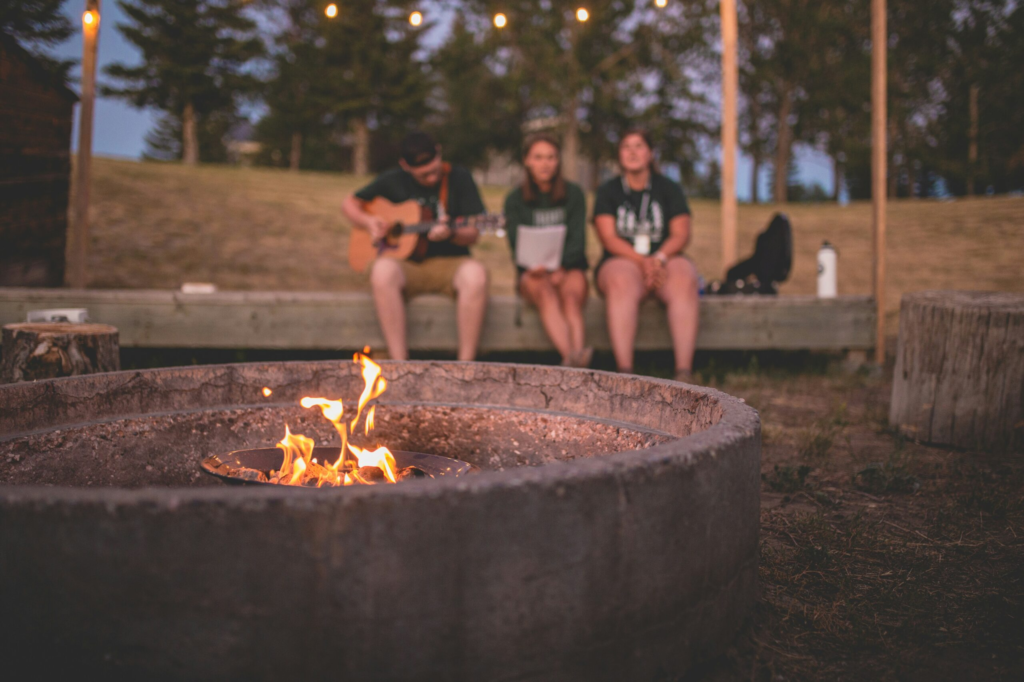 group of summer camp staff around a fire