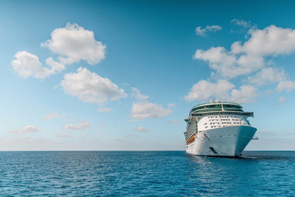 cruise ship floating at sea under a clear blue sky