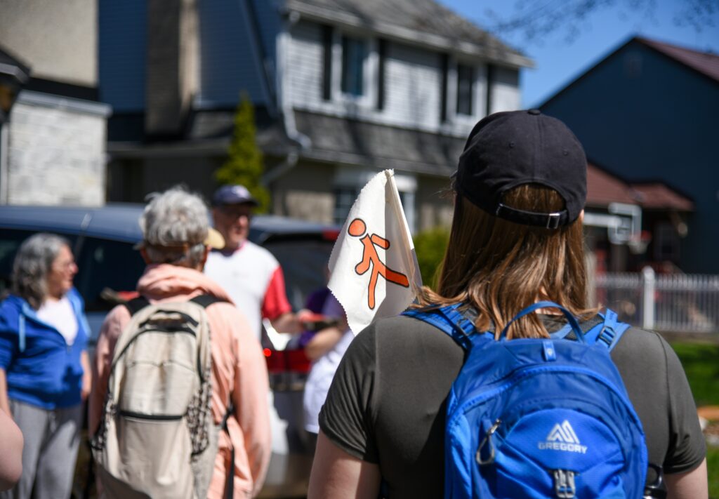 a summer tour guide walking a group through a small town