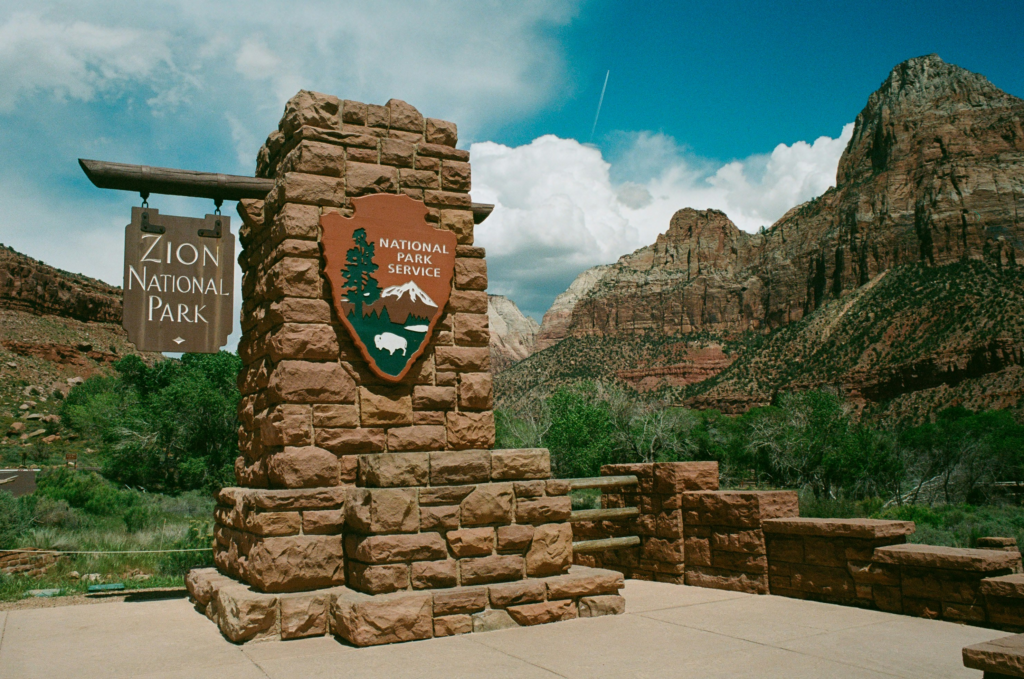 National park emblem next to a Zion National Park sign