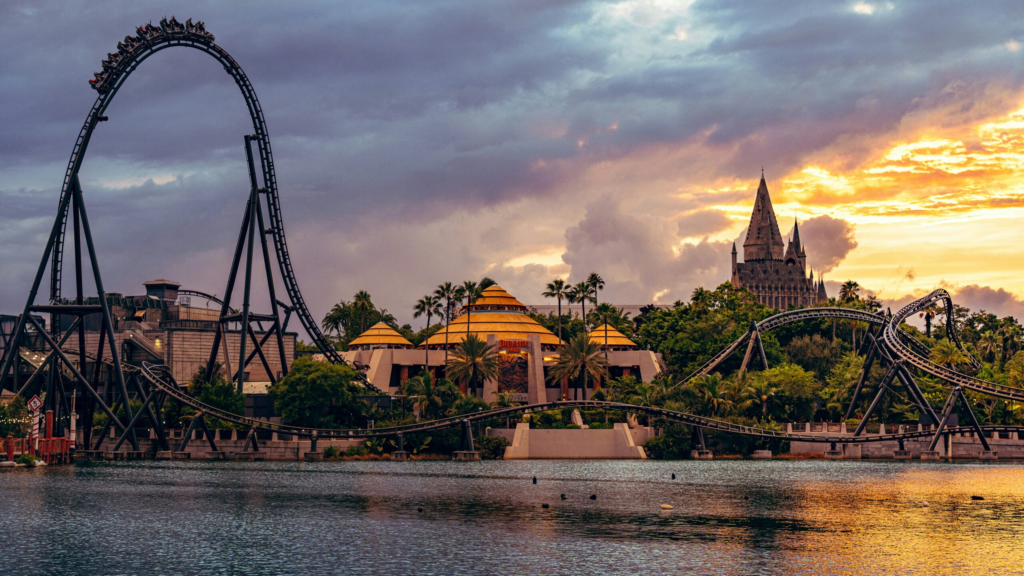 the sun sets behind a roller coaster in universal studio islands of adventure theme park