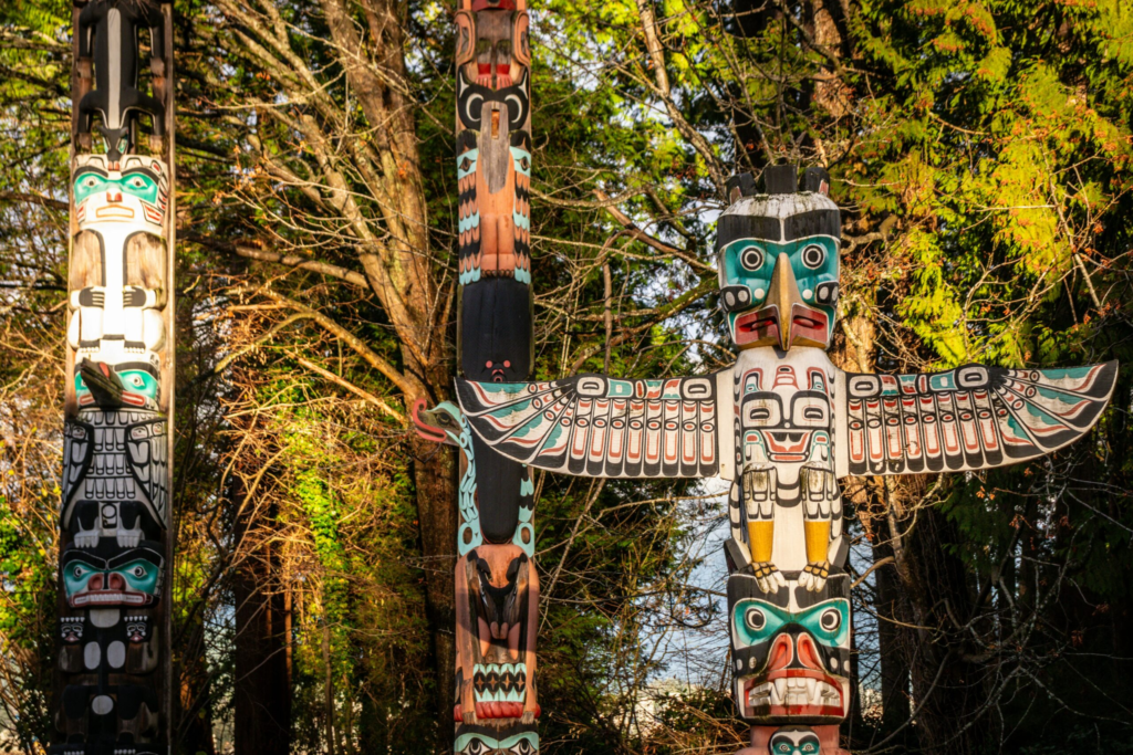 three totem poles from an indigenous tribe in Vancouver, Canada