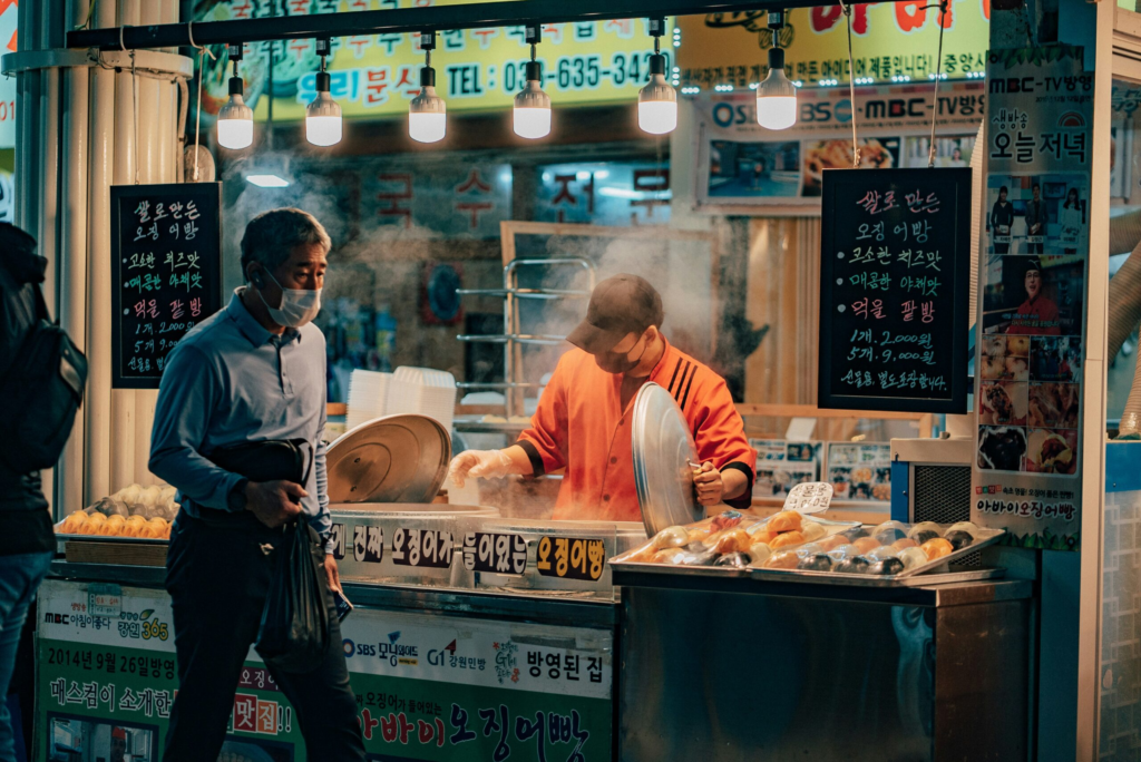 a food vendor sets up his nightly food stall on a street in South Korea