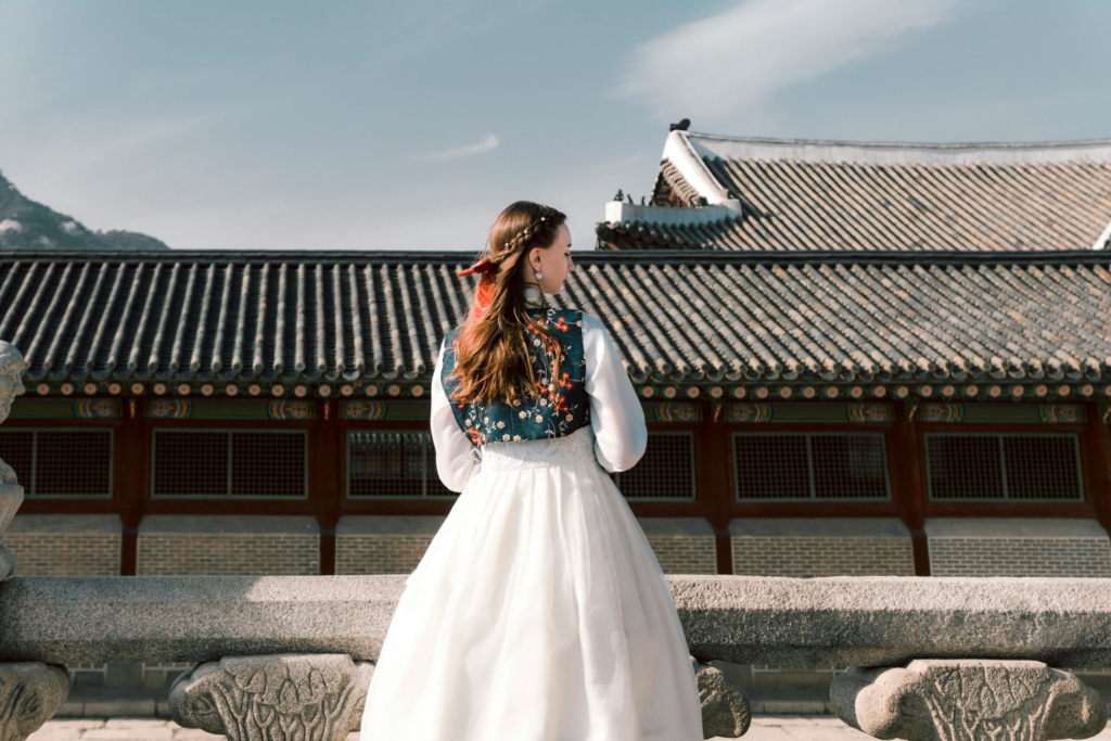 a women in a white hanbok explores South Korea 