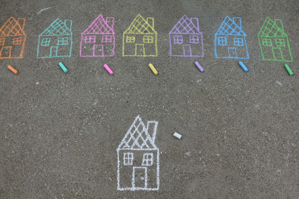 chalk drawings of different colored houses on the pavement