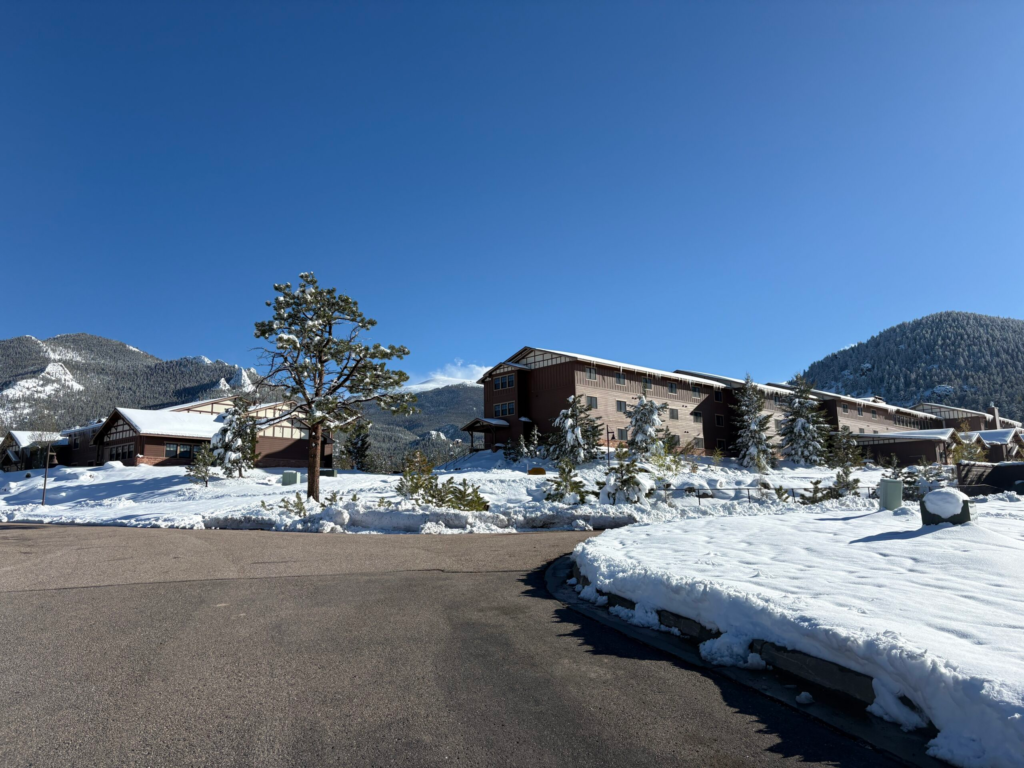 Lodges at the YMCA of the Rockies during snowfall.