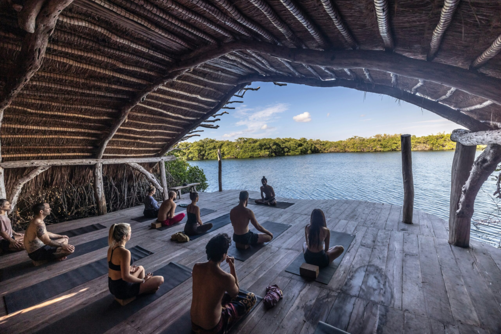 a yoga instructor teaches a group yoga class abroad